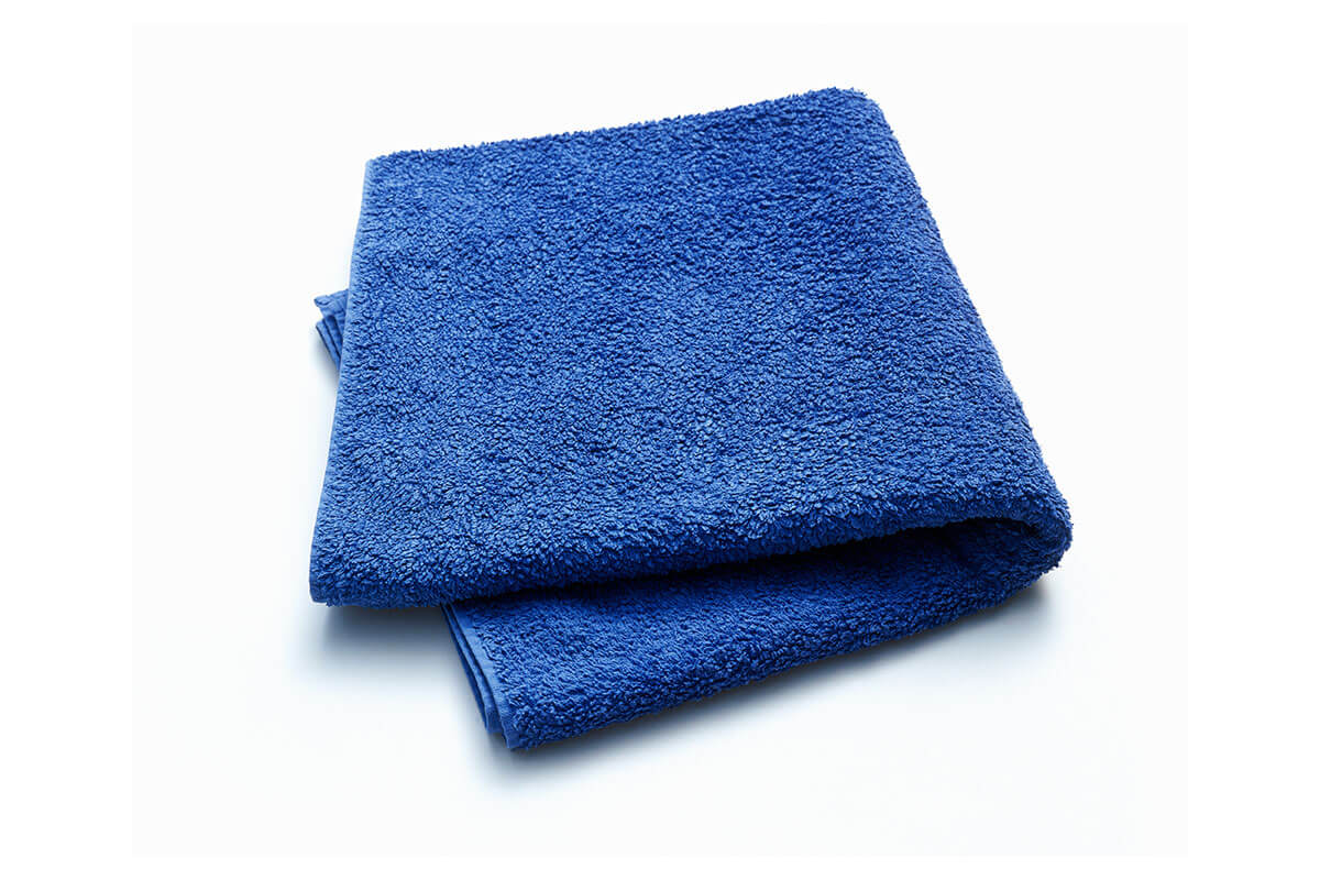 curl-friendly towels use a microfiber material towel to soften hair when drying
