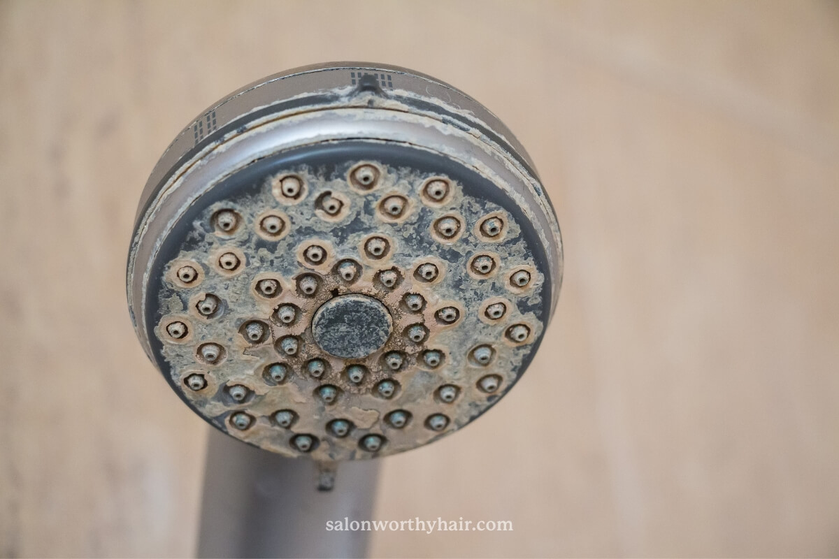 build up of hard water can cause oily hair because it clogs the scalp pores with minerals that overstimulate the scalp