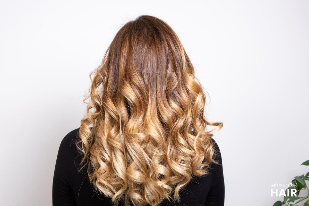 Balayage blonde boasts hand-painted, sun-kissed highlights transitioning from darker roots to lighter tips, offering a natural, low-maintenance, and tailored look.
