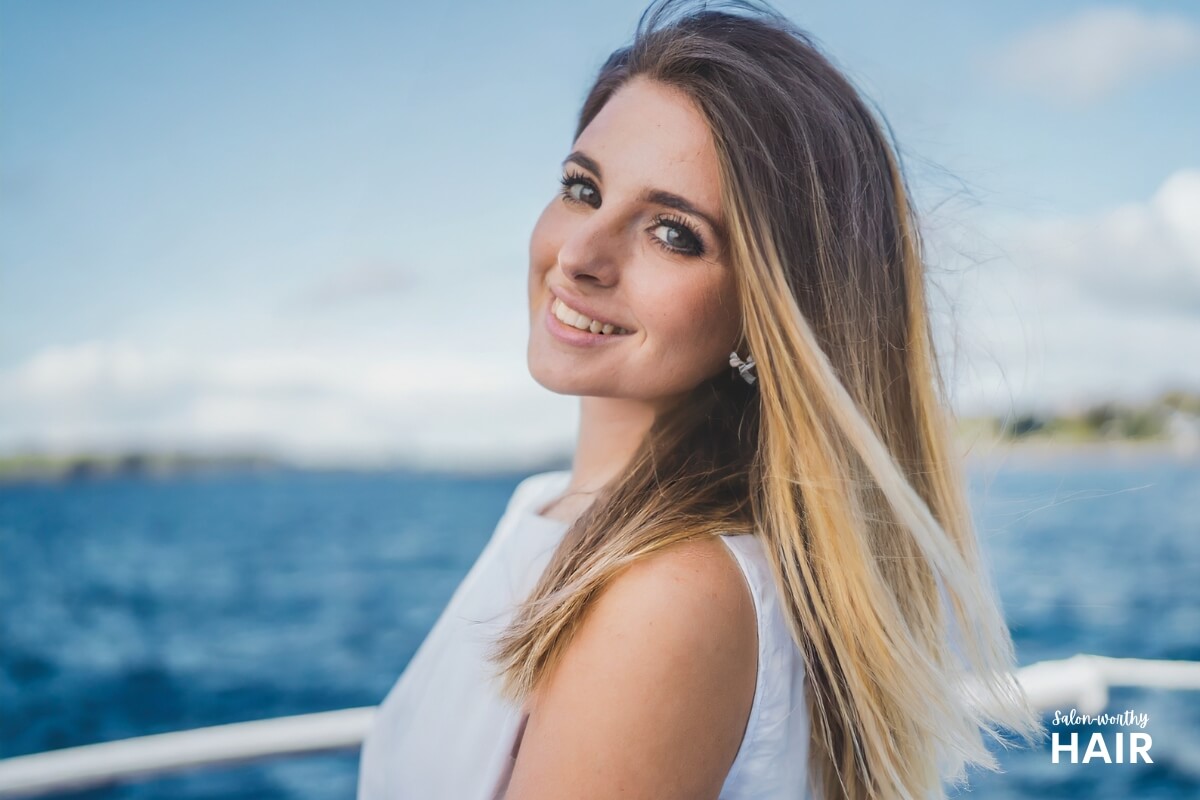 Ombre blonde hair boasts a gradient transition from darker roots to lighter ends, offering a versatile, seamless blend of two distinct shades.