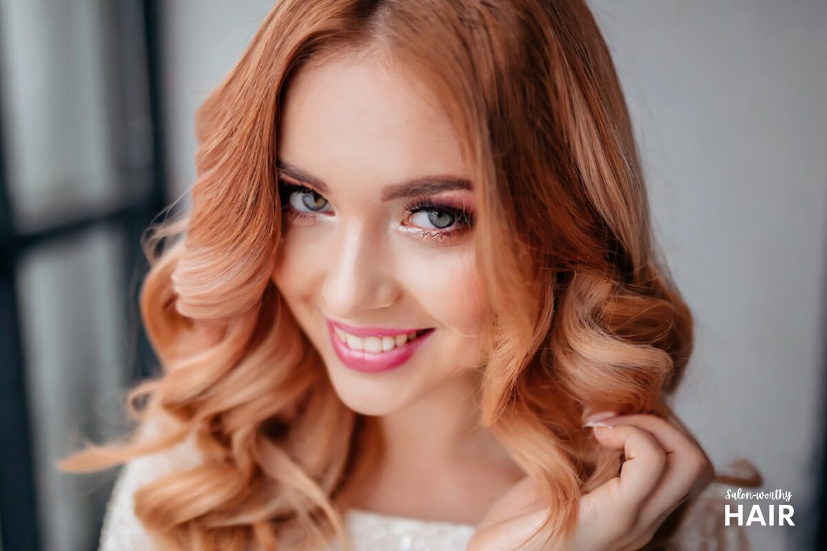 Strawberry blonde hair is a light, golden-red shade blending warm blonde hues with soft reddish undertones, evoking the color of sun-kissed strawberries.