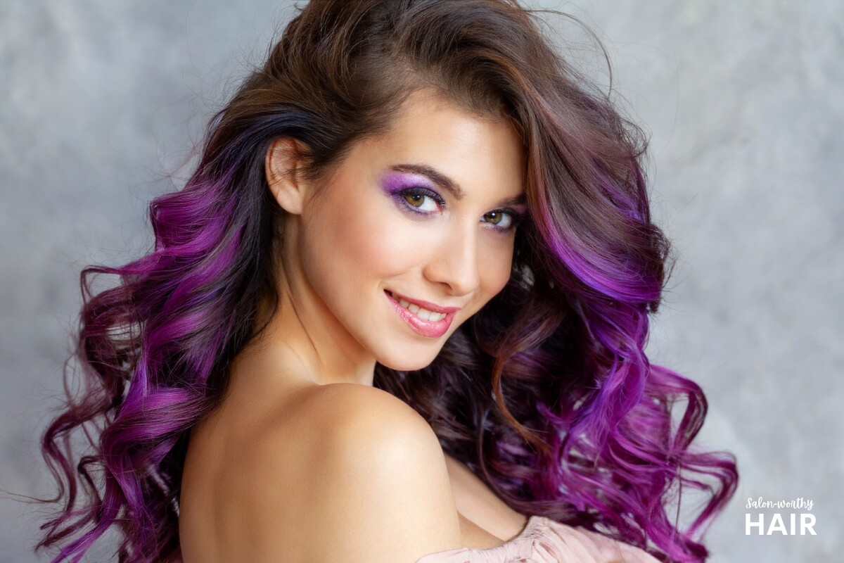 woman with violet hair dye on dark hair color achieved without using bleach